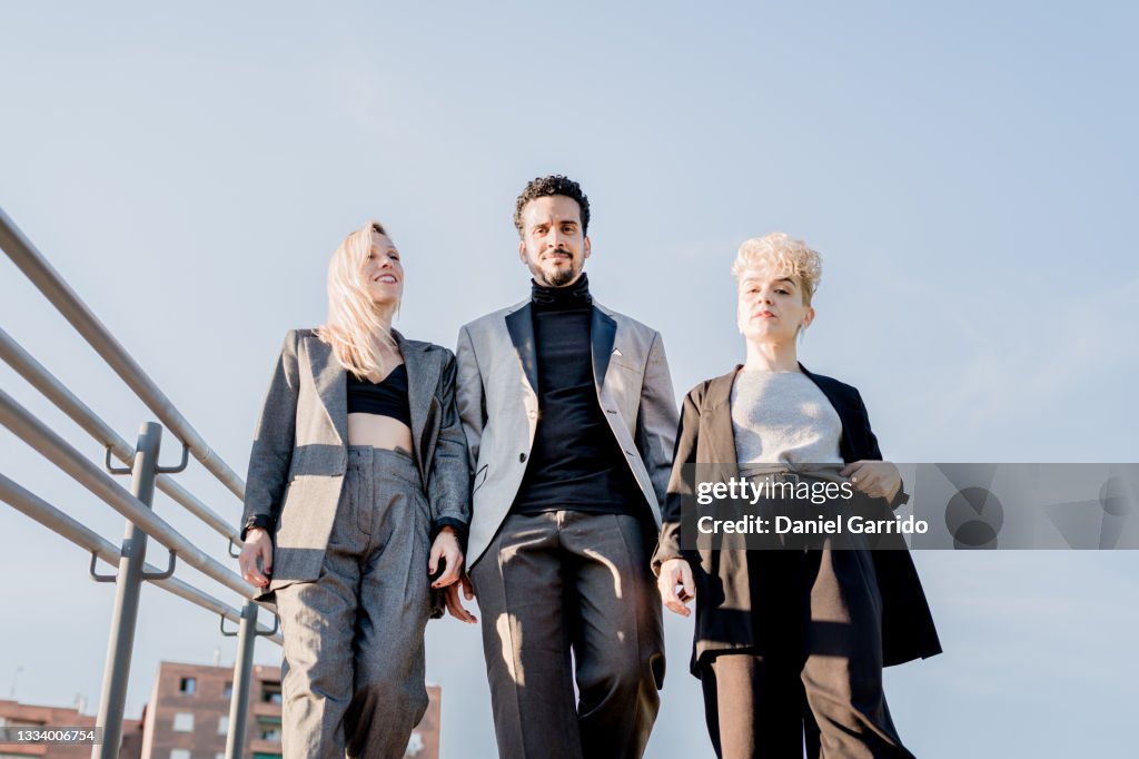 Lifestyle of three business friends, on some stairs