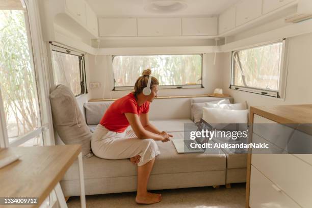 having a conference call while sitting in the recreational vehicle - voertuiginterieur stockfoto's en -beelden