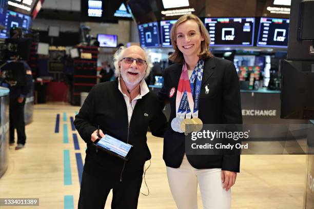 Peter Tuchman poses for a photo with Olympic swimmer Katie Ledecky at the New York Stock Exchange on August 13, 2021 in New York City.