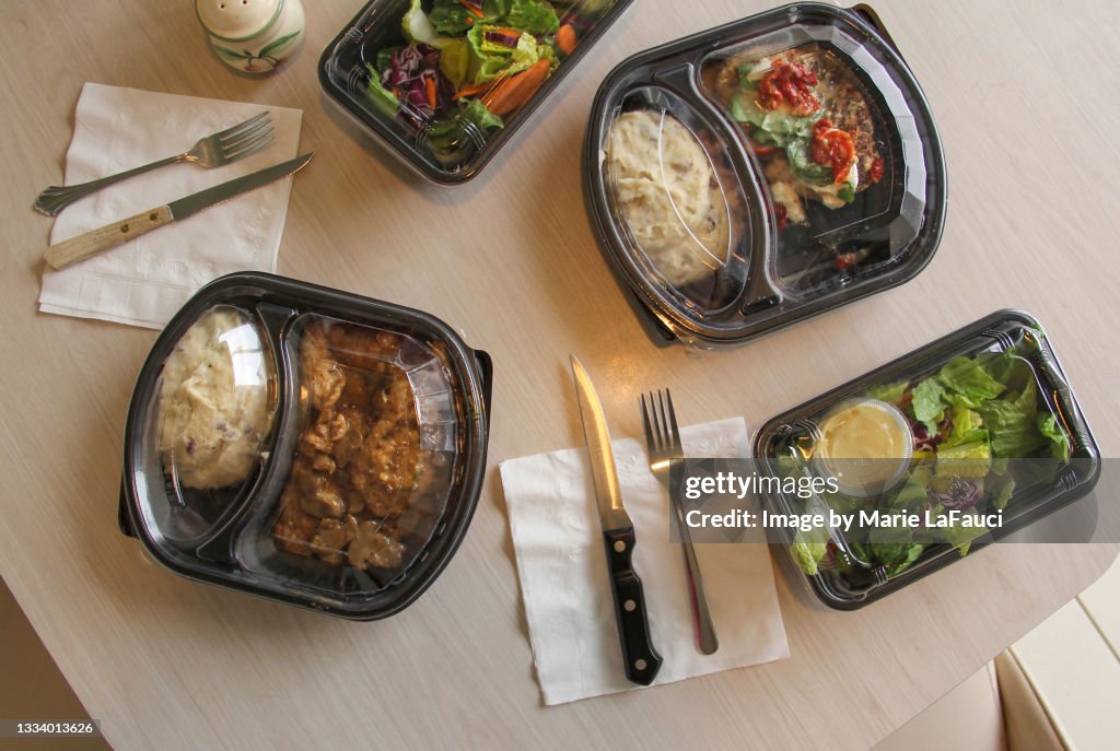 Plastic containers of food at kitchen table