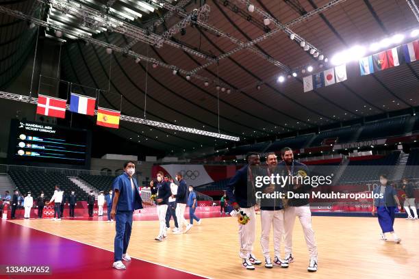 Luc Abalo, Michael Guigou and Nikola Karabatic of Team France pose after the medal ceremony for Men's Handball after winning the gold medal on day...