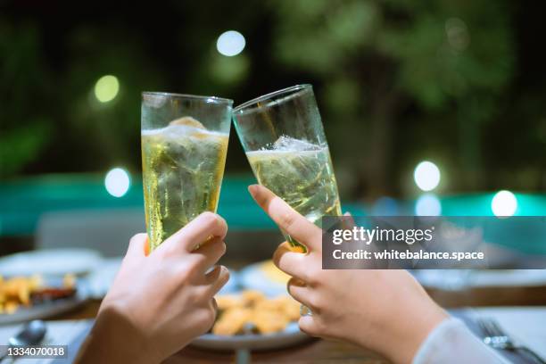happy friends clink a glass of beer in the house. - energy drink stock pictures, royalty-free photos & images