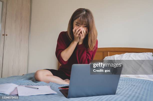 young university student feeling surprise and excited celebrating her success with laptop on bed - scholarship award stock pictures, royalty-free photos & images