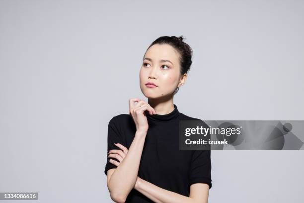 thoughtful asian young woman - front looking asian women stock pictures, royalty-free photos & images