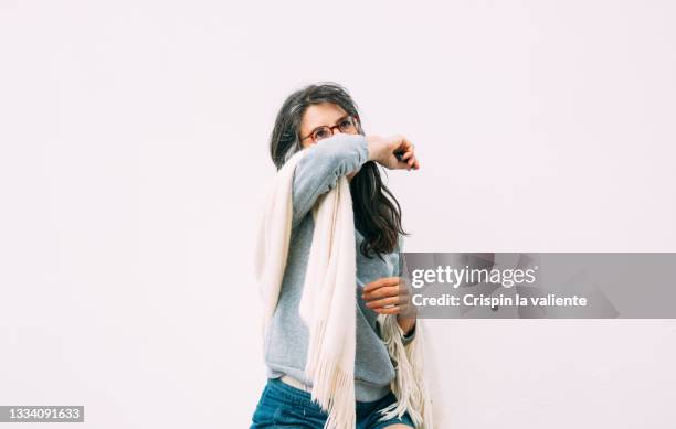 allergy, adult woman covering her mouth with her arm - husten stock-fotos und bilder