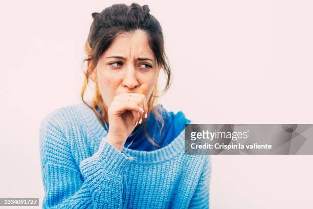 portrait of teenager girl coughing, sore throat with white background - spain teen face bildbanksfoton och bilder