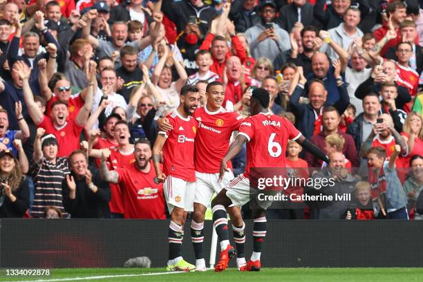 Bruno Fernandes of Manchester United celebrates with teammates Mason Greenwood and Paul Pogba after scoring their side's first goal during the...