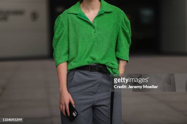 Maria Barteczko wearing green terry polo shirt, Zara grey pants and the Frankie shop leather belt on August 08, 2021 in Dusseldorf, Germany.