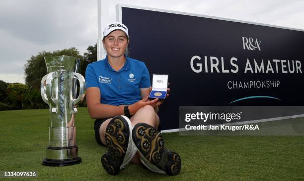 Hannah Darling of Broomieknowe poses with the trophy following victory in the R&A Girls Amateur Championship at Fulford Golf Club on August 14, 2021...