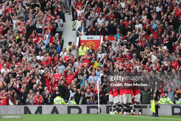 Fans celebrate the fourth goal scored by Bruno Fernandes of Manchester United and his hat-trick during the Premier League match between Manchester...