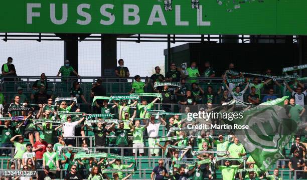 VfL Wolfsburg fans show their support prior to the Bundesliga match between VfL Wolfsburg and VfL Bochum at Volkswagen Arena on August 14, 2021 in...