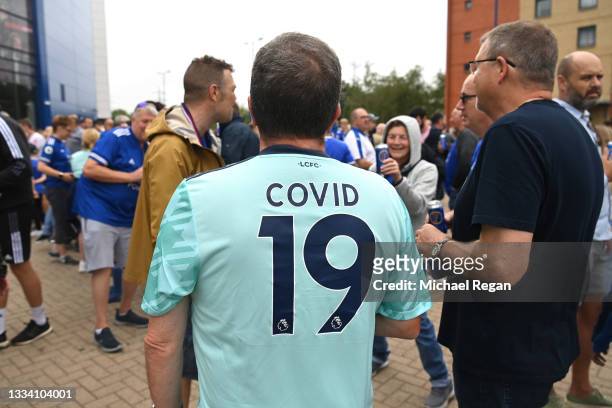 Fan wearing a shirt with 'Covid 19' on the back is seen arriving at the stadium ahead of the Premier League match between Leicester City and...