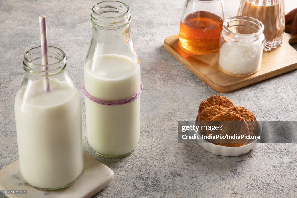 Milk bottles with cookies sugar and honey