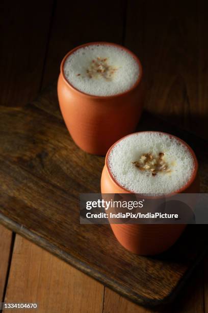 butter milk in a earthan glass - lassi stock pictures, royalty-free photos & images