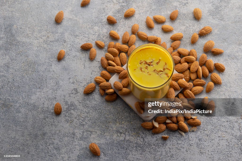 Top view of Turmeric milk with almonds