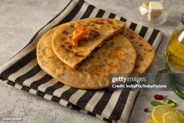 tasty stuffed paranthas served with pickle on top - panir stock pictures, royalty-free photos & images