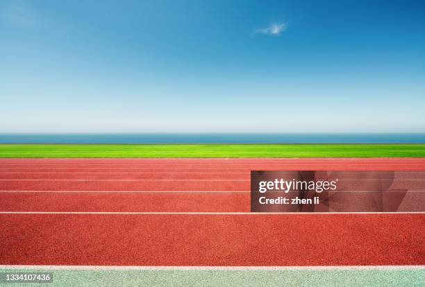 sports track by the sea - track and field stadium stock pictures, royalty-free photos & images