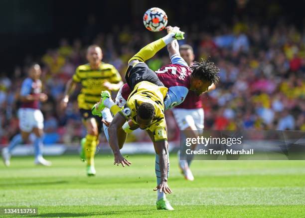 Emmanuel Dennis of Watford is challenged by Tyrone Mings of Aston Villa during the Premier League match between Watford and Aston Villa at Vicarage...