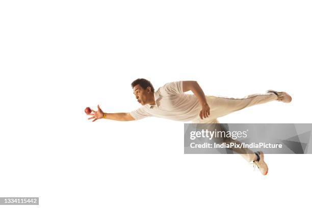 fielder diving to take a ctach - man catching stock pictures, royalty-free photos & images