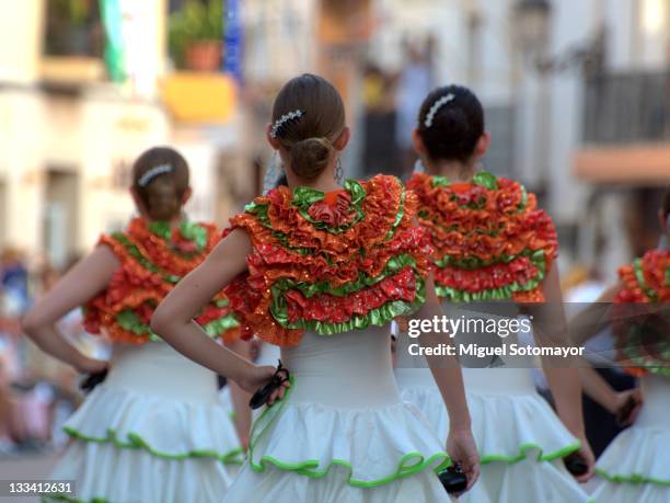 women dressed as "flamencas" in parade - flamenco danza tradizionale foto e immagini stock