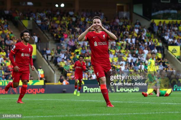Diogo Jota of Liverpool celebrates after scoring their side's first goal during the Premier League match between Norwich City and Liverpool at Carrow...