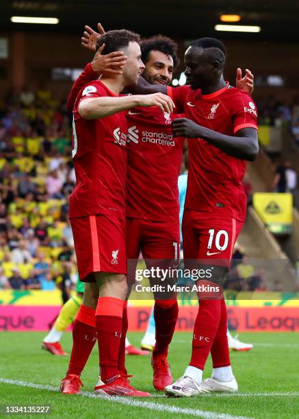 Diogo Jota of Liverpool celebrates with teammates Mohamed Salah and Sadio Mane after scoring their side's first goal during the Premier League match...