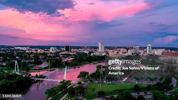 drone aerial view of downtown wichita skyline, kansas features arkansas rivers bridges and exploration place science museum - wichita stock pictures, royalty-free photos & images
