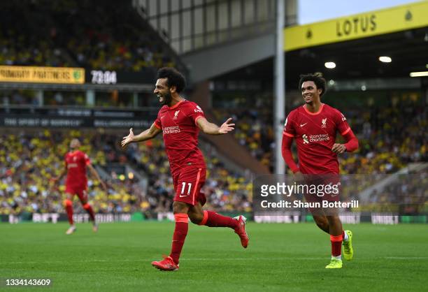 Mohamed Salah of Liverpool celebrates with teammate Trent Alexander-Arnold after scoring their side's third goal during the Premier League match...