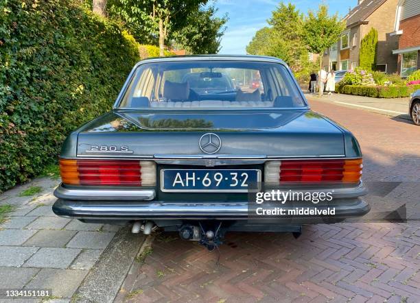 retro car parked in the street - license plate stock pictures, royalty-free photos & images