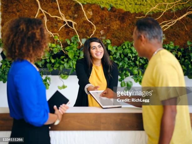 business lobby receptionist - receptionist stock pictures, royalty-free photos & images