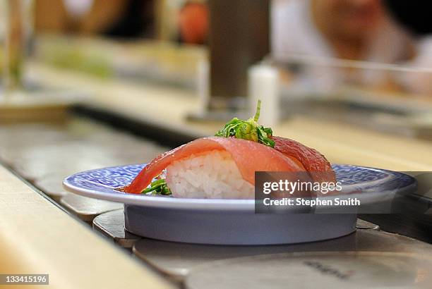 sushi on conveyor belt - sushi bar stock pictures, royalty-free photos & images