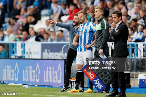 Carlos Coberán the Head Coach of Huddersfield Town gives last bits of coaching to new substitute Jordan Rhodes during the Sky Bet Championship match...