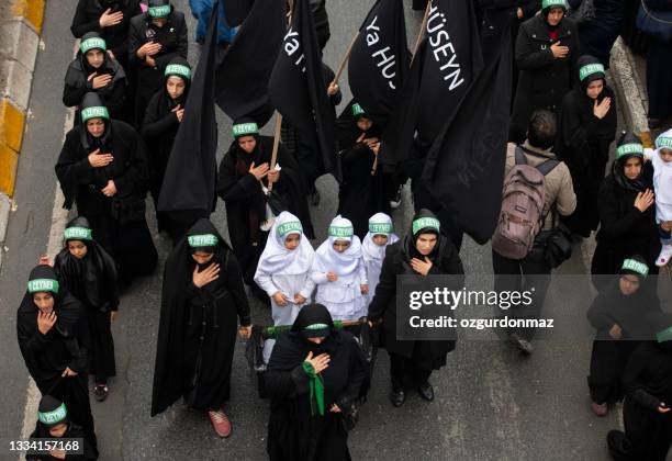crowd of shiite muslim women walking and protesting during the remembrance of muharram (called asura) in halkali, istanbul - iranian people stock pictures, royalty-free photos & images