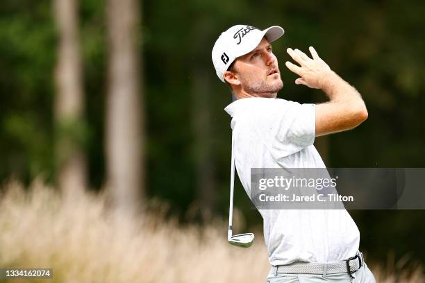 Russell Henley of the United States watches his shot from the 12th tee during the third round of the Wyndham Championship at Sedgefield Country Club...