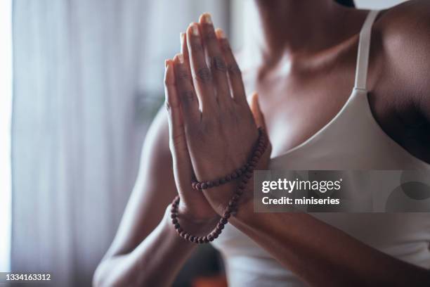 close up photo of unrecognizable woman hands in namaste gesture holding male beads - namaste bildbanksfoton och bilder