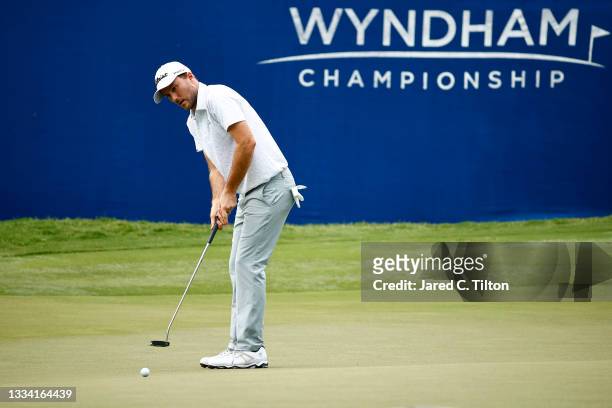 Russell Henley of the United States putts on the 18th green during the third round of the Wyndham Championship at Sedgefield Country Club on August...