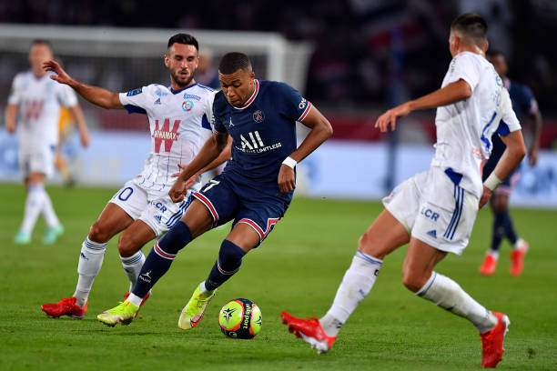 Kylian Mbappe of Paris Saint-Germain fights for possession during the Ligue 1 Uber Eats match between Paris Saint Germain and Strasbourg at Parc des...