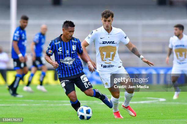 Osvaldo Martinez of Queretaro fights for the ball with Juan Ignacio Dinenno of Pumas during the 4th round match between Pumas UNAM and Queretaro as...