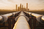 Oil Refinery And Pipeline In Desert During Sunset