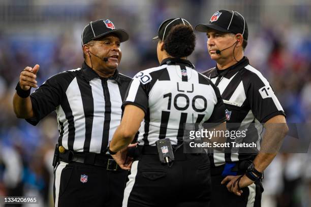 Referees meet to discuss a play during the first half of a preseason game between the Baltimore Ravens and the New Orleans Saints at M&T Bank Stadium...