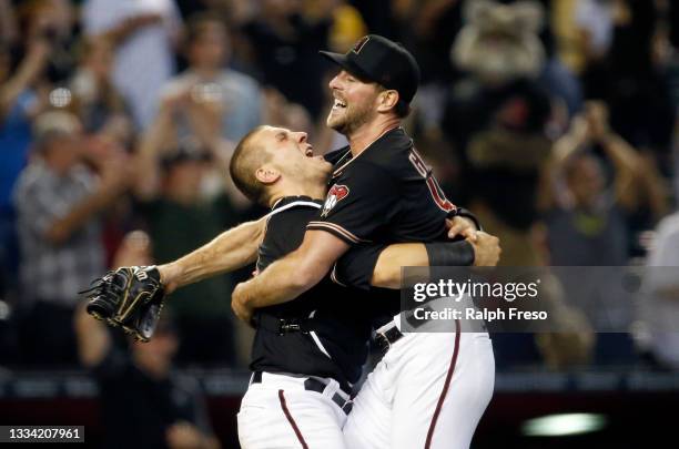 Starting pitcher Tyler Gilbert of the Arizona Diamondbacks jumps into the arms of catcher Daulton Varsho of the Diamondbacks as they celebrate...