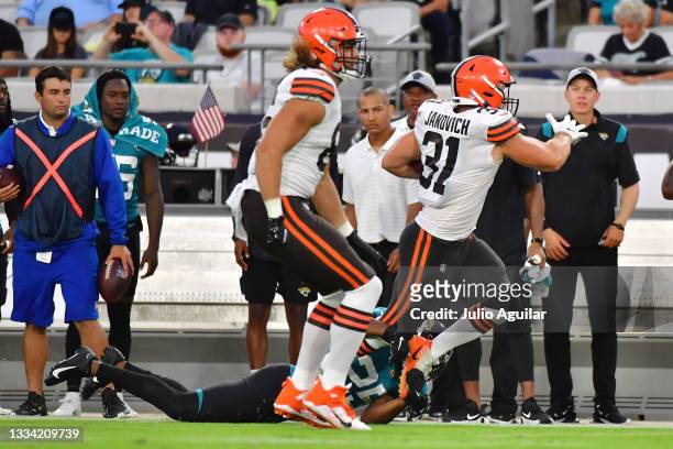 Andy Janovich of the Cleveland Browns is brought down by Jarrod Wilson of the Jacksonville Jaguars in the second quarter during a preseason game at...