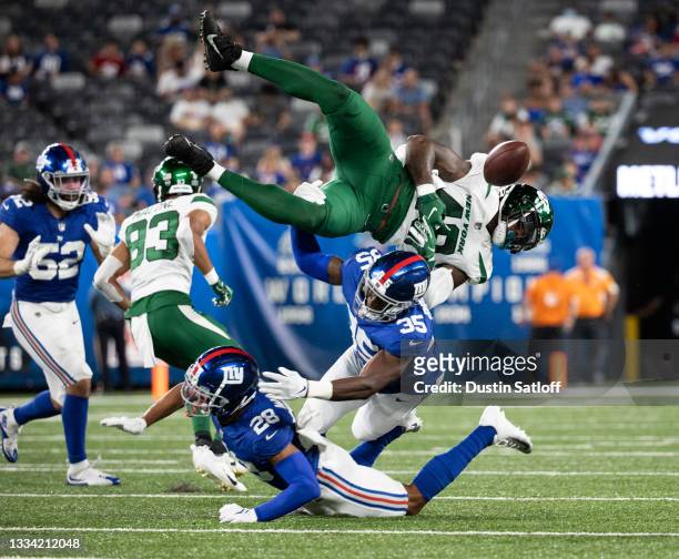 Quincy Wilson of the New York Giants and TJ Brunson of the New York Giants force Kenny Yeboah of the New York Jets to fumble the ball during the...