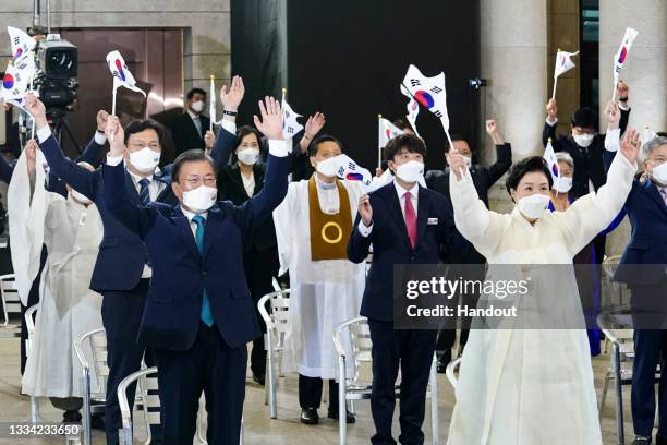 In this handout image provided by South Korean Presidential Blue House, South Korean President Moon Jae-in and his wife Kim Jung-sook cheer during...