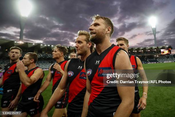 Essendon player celebrate their win after the round 22 AFL match between Gold Coast Suns and Essendon Bombers at GMHBA Stadium on August 15, 2021 in...