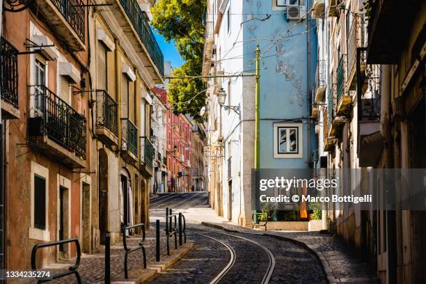 old town and tramway rails in lisbon, portugal - provincie lissabon stockfoto's en -beelden