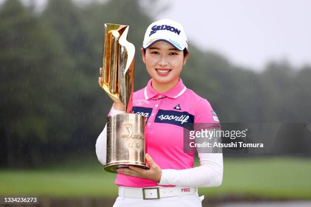 Sakura Koiwai of Japan poses with the trophy after winning the tournament following the final round of the NEC Karuizawa 72 Golf Tournament at...