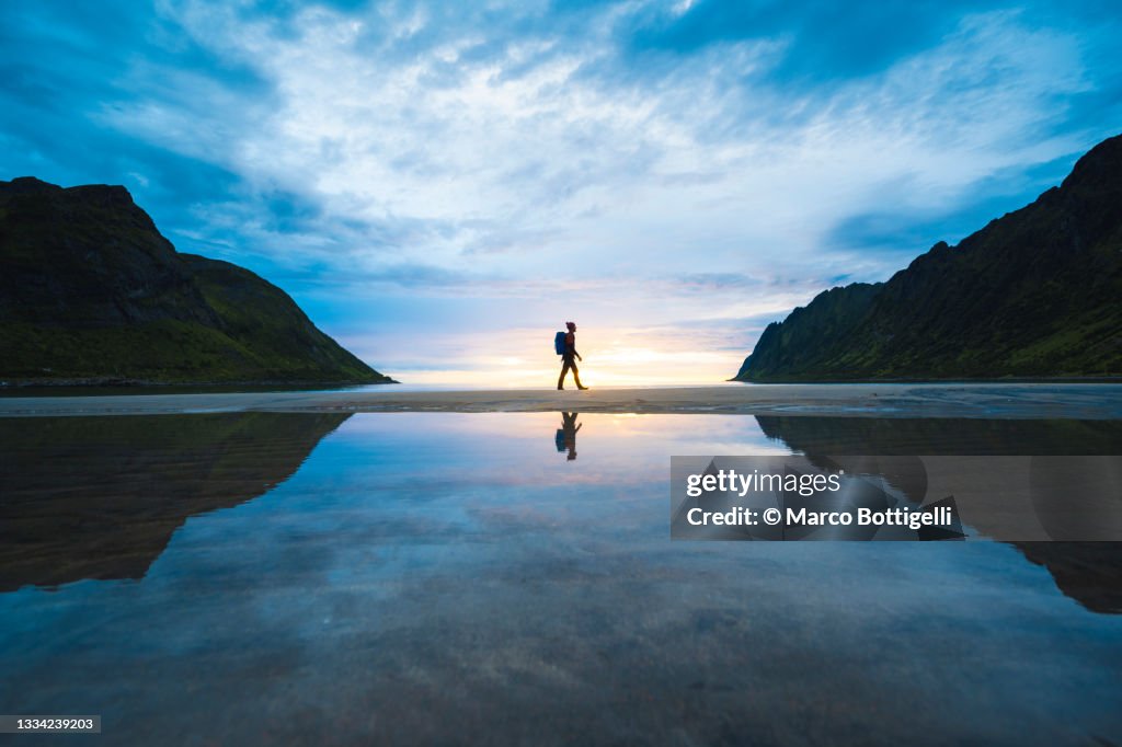 Person walking on the baech at sunset, Senja, Norway