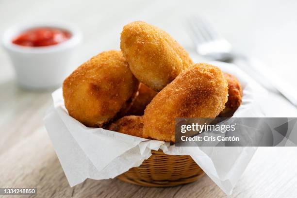 homemade croquetas with tomato sauce - kroket stockfoto's en -beelden