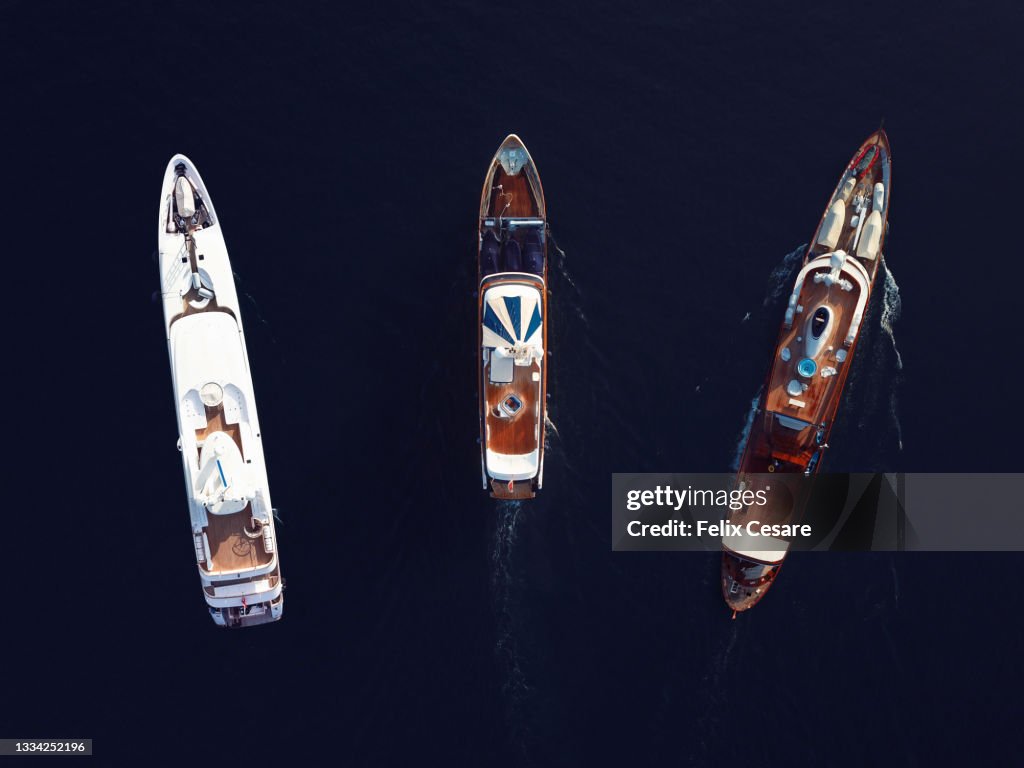 Aerial View of Three Luxury Super Yachts
